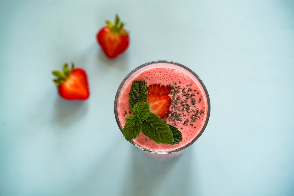 Strawberry Coconut Smoothie garnished with strawberry and chia seeds