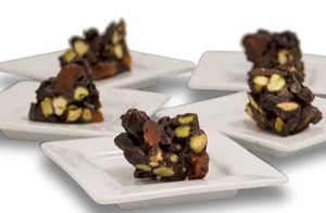Raw Chocolate and Nut Clusters on white plates