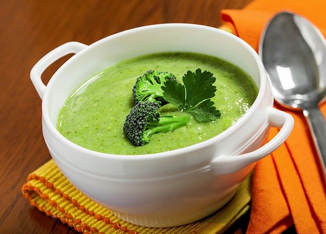 Nutty Broccoli Soup with a Spoon and Tablecloth
