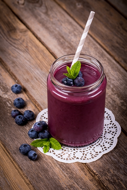 Blueberry Mint Smoothie in glass cup with straw